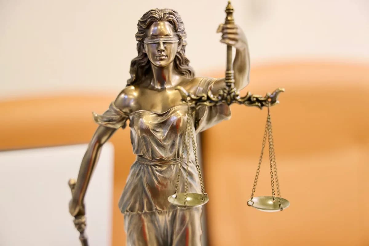 Close-up of Lady Justice statue holding scales and sword