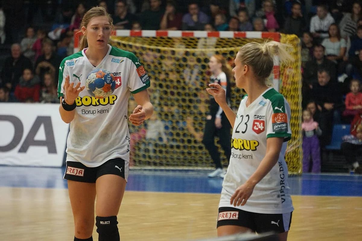 Two Viborg HK handball players in action during a match.