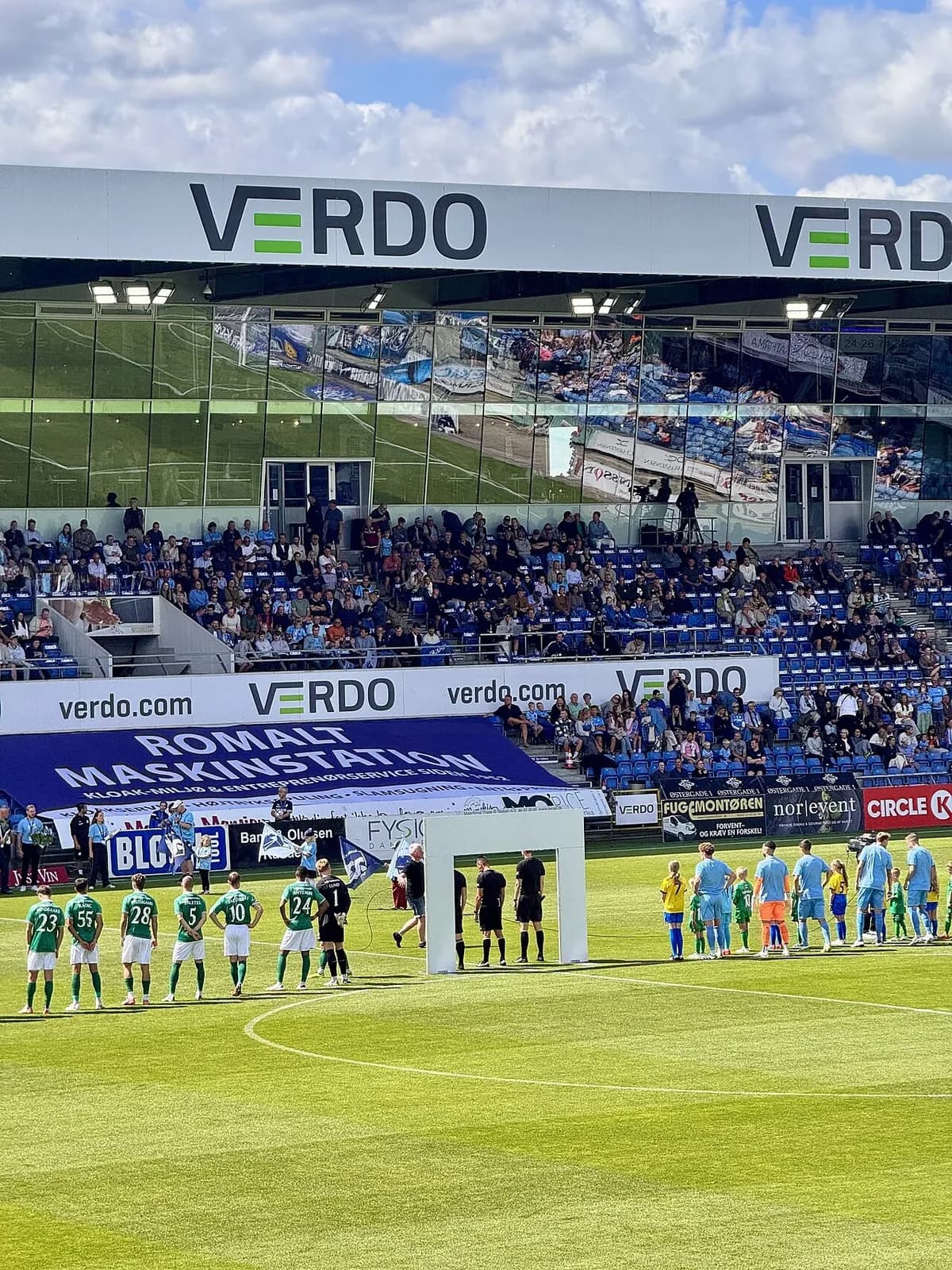Football teams lined up before match at Vejle Boldklub stadium