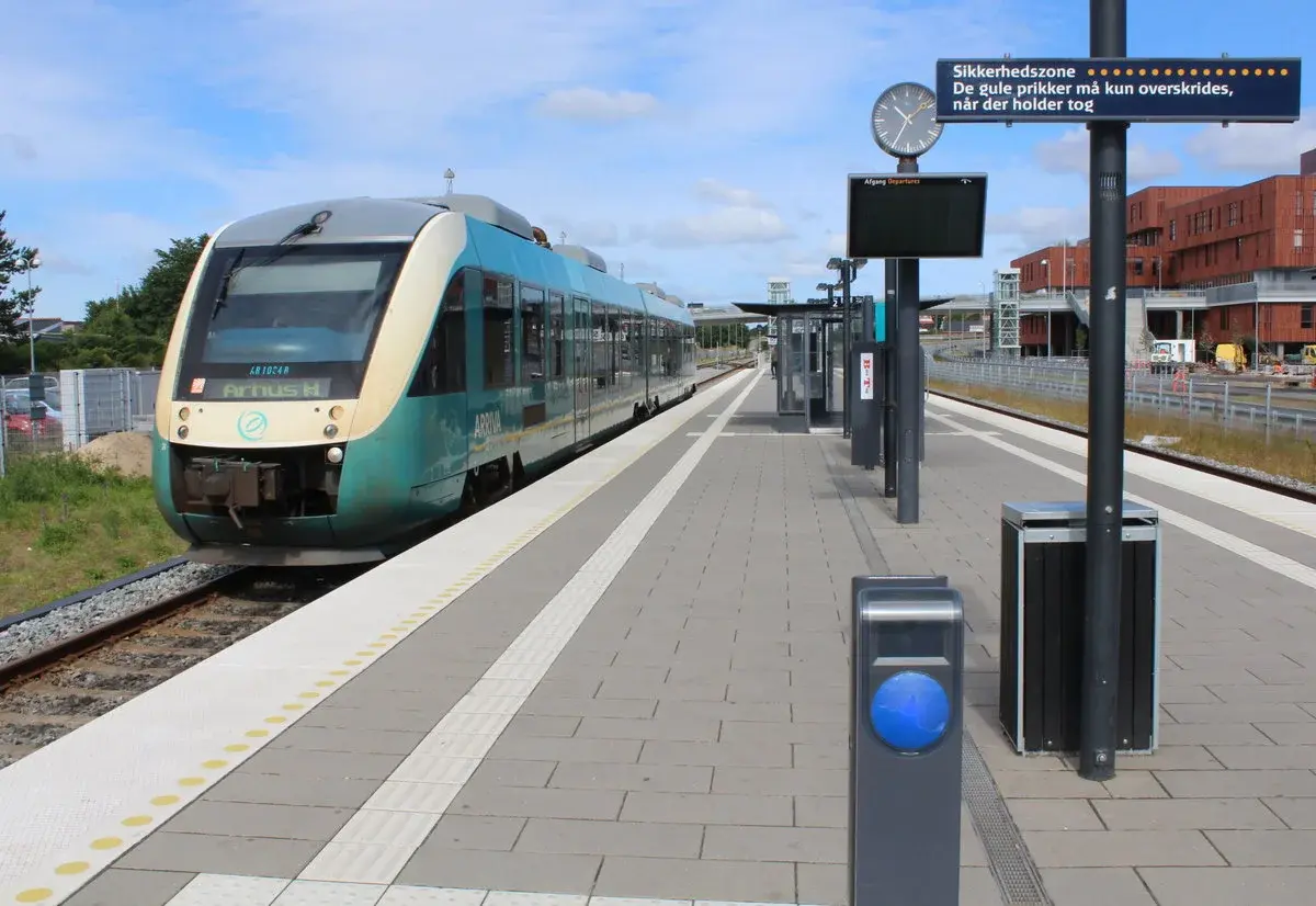 An Arriva train waiting at Viborg station platform.