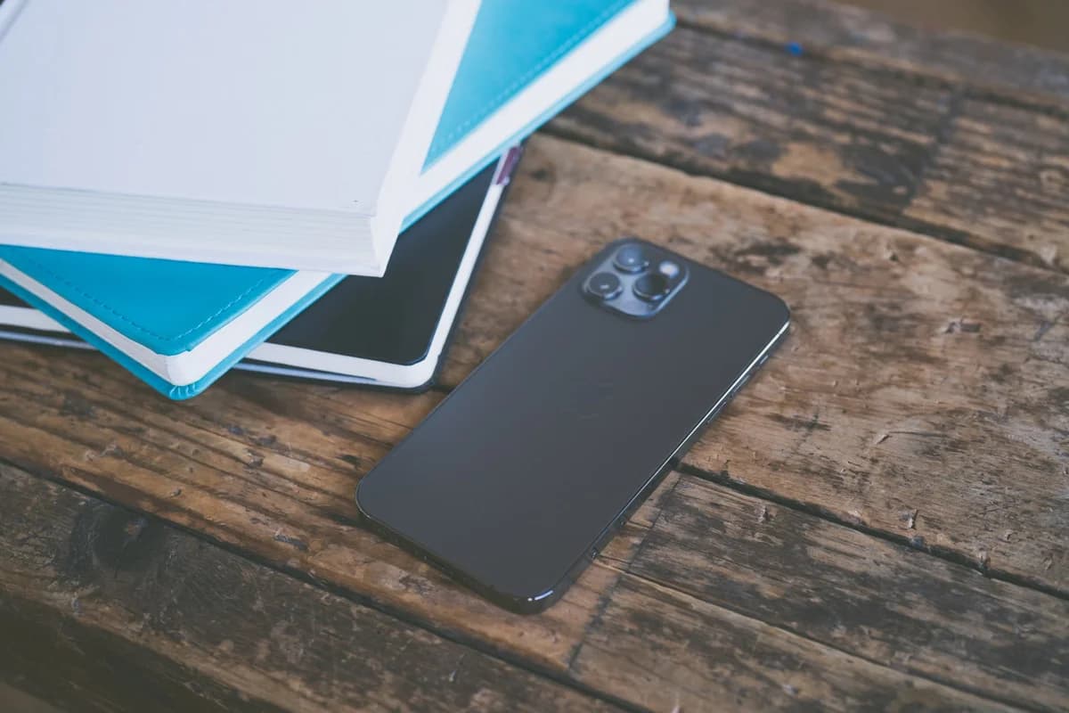 Smartphone and notebooks on a rustic wooden table