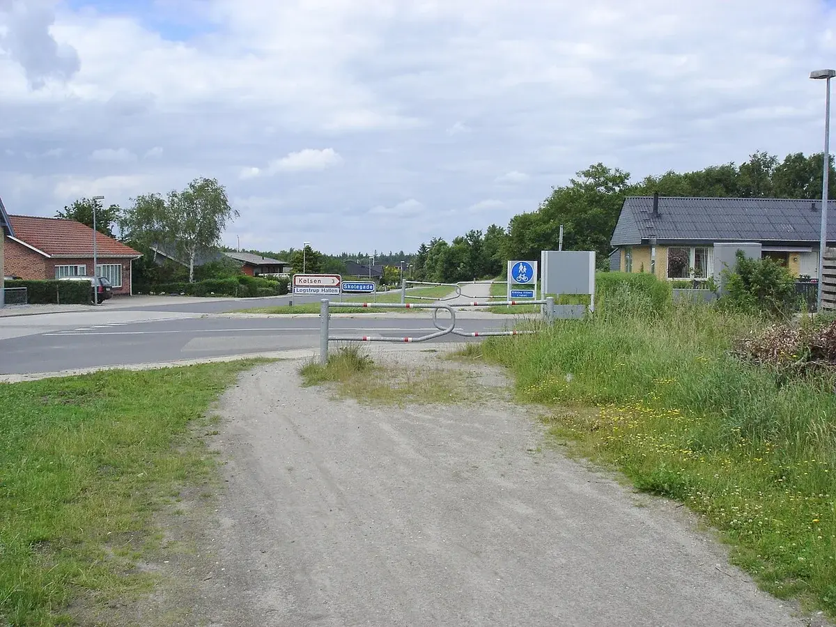 A gravel path crossing a road in a Danish residential area.