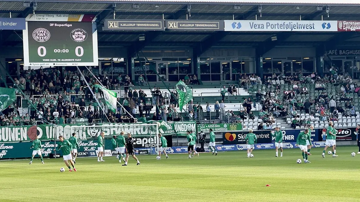 Viborg FF players warming up on the field at Energi Viborg Arena.