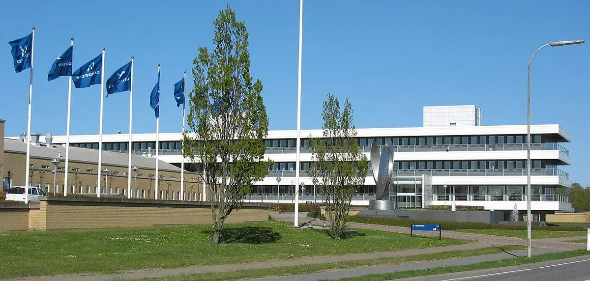 Modern office buildings with Grundfos flags flying outside.